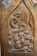 Two serpents attacking a man
