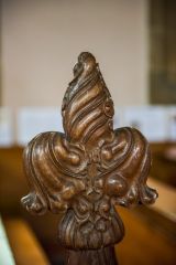 A finely-carved poppyhead bench end