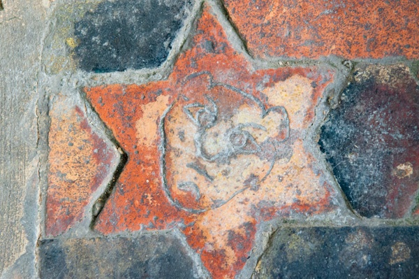 Medieval floor tile of a human face