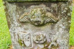 A worn gravestone in the churchyard