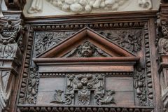 Richly detailed wood carving over the doorway
