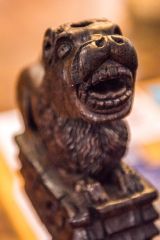 A carved medieval bench end depicting a lion