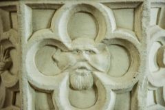 A carved face on the medieval font, St Nicholas Church