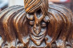 A 15th-century poppyhead bench end carving
