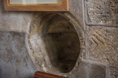 A peculiar holy water stoup inside the south door