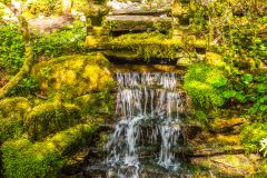A small waterfall below the koi pond