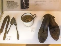 Utinsils, mug and boots from WWII concentration camps