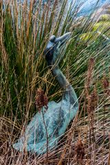 A heron sculpture beside the pool