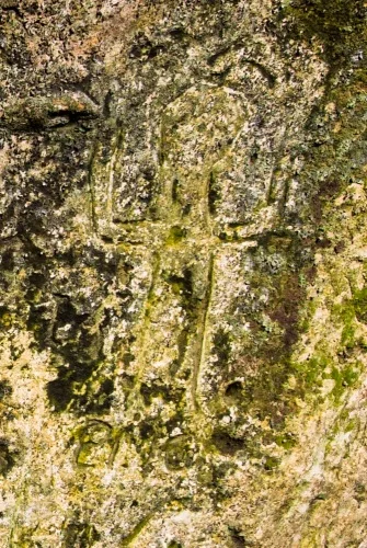 Carving of a man with raised arms