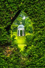 The Grecian temple seen through a 'portal' in the hedge