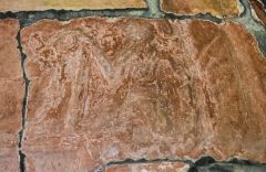 Worn carving of a figure on the north doorway tympanum