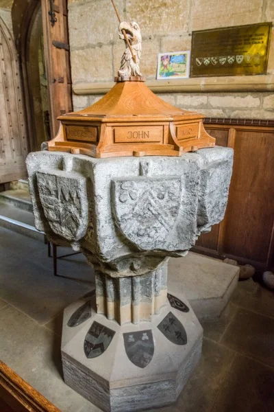The ornately carved medieval font