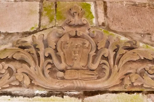 A heraldic crest on the nave wall