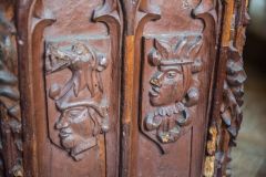 Carved heads on late medieval bench ands