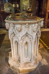 The richly carved medieval font