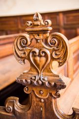 A carved bench end