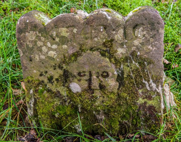 Gravestone with grotesque carving