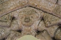 Carved head of a lion on the south doorway