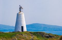 The whitewashed conical lighthouse