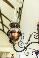 A Victorian oil lamp on the nave wall