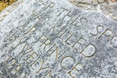 Inscribed stone beside the path