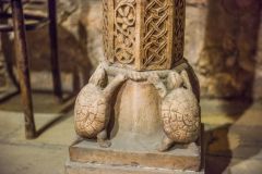 Carved turtles support the font shaft