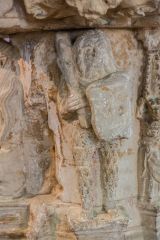 Carving of a male woodwose on the font stem