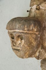 A worn 12th-century carved head
