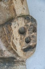 A carved head by the south door