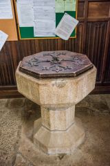 The plainly carved octagonal font