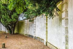 The curving wall beside the main house