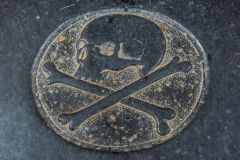 Reminder of mortality on the ledger slab of John Bear, d. 1733