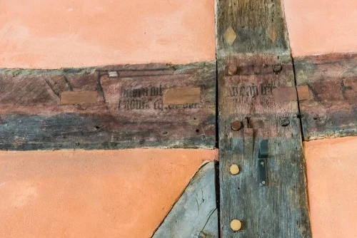 A painted timber beam in the Great Hall