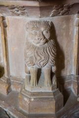 Carved lion on the font base