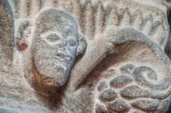 Carved head on a nave capital