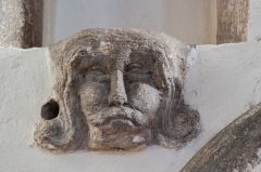 Carved head on the piscina