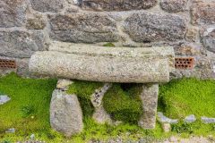 A rustic stone bench outside the Old School House
