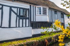A timber-framed house on the river bank