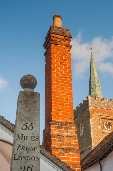 A picturesque spire, chimney, and milestone