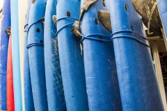 Surfboards outside a shop by the beach