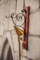 A candle-snuffer on its hook