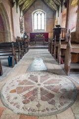 The peculiar wheel-cross design in the nave floor
