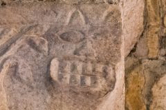 Detail of a grinning face carving