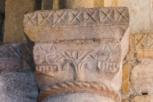 Grinning faces on the chancel arch