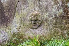 Carved face on a gravestone in the churchyard