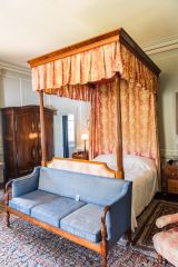 A four-poster bed, first floor