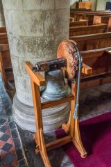 An old bell stands in the nave