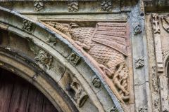 Carving of a dragon in the south porch archway spandrel