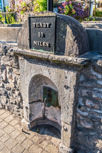 Mile post and old drinking tap near Orielton Terrace
