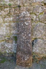 An ancient cross stands within the priory ruins